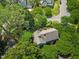 Aerial view of a house nestled among lush, mature trees in a quiet and verdant neighborhood at 1806 Carrington Dr, Raleigh, NC 27615
