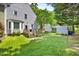 Beautiful backyard with a wooden deck and a stone pathway leading to additional yard space at 1806 Carrington Dr, Raleigh, NC 27615