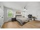 Neutral bedroom featuring a ceiling fan, dual closets, natural light, and a dedicated workspace at 1806 Carrington Dr, Raleigh, NC 27615