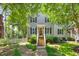Charming two-story home featuring gray siding, black shutters, a red front door, and a welcoming front yard at 1806 Carrington Dr, Raleigh, NC 27615
