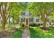 Charming two-story home featuring gray siding, black shutters, a red front door, and a lush front yard at 1806 Carrington Dr, Raleigh, NC 27615