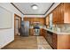 Well-lit kitchen with stainless steel appliances, wood cabinets, and wood-style flooring at 1806 Carrington Dr, Raleigh, NC 27615