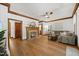 Bright living room featuring a brick fireplace, stylish furniture, decor, and hardwood floors at 1806 Carrington Dr, Raleigh, NC 27615