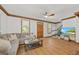 Bright living room boasts wood floors, stylish furniture, and a view to the backyard at 1806 Carrington Dr, Raleigh, NC 27615