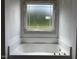 Bathroom featuring a soaking tub and large window bringing natural light at 196 Cozy Brook Ct, Clayton, NC 27520
