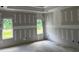Bright bedroom featuring multiple windows and unfinished walls at 196 Cozy Brook Ct, Clayton, NC 27520