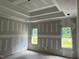 Bright bedroom featuring recessed lights, multiple windows and unfinished walls at 196 Cozy Brook Ct, Clayton, NC 27520