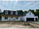 Exterior of a new home build with two-car garage and black roof at 196 Cozy Brook Ct, Clayton, NC 27520