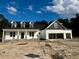 New construction home featuring a two-car garage and dormer windows under a cloudy sky at 196 Cozy Brook Ct, Clayton, NC 27520