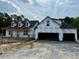 Exterior of a new home build with two-car garage and black roof at 196 Cozy Brook Ct, Clayton, NC 27520