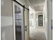 Hallway featuring a sliding barn door and view of decorative columns at 196 Cozy Brook Ct, Clayton, NC 27520