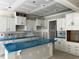 A view of a bright and modern kitchen under construction with white cabinets and a large island at 196 Cozy Brook Ct, Clayton, NC 27520