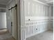View of a room under construction with board and batten wall accents and a sliding barn door at 196 Cozy Brook Ct, Clayton, NC 27520