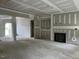 Bright living room featuring unfinished walls, fireplace and entryway to other parts of the house at 196 Cozy Brook Ct, Clayton, NC 27520