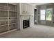 Bright living room under construction, with a fireplace and built-in shelving at 196 Cozy Brook Ct, Clayton, NC 27520
