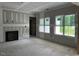 Bright living room featuring unfinished walls, fireplace, and windows bringing natural light at 196 Cozy Brook Ct, Clayton, NC 27520