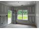 Bright living room featuring an exterior door and windows bringing natural light at 196 Cozy Brook Ct, Clayton, NC 27520