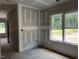 Bright room featuring fresh drywall and large windows with a view of the outdoors at 196 Cozy Brook Ct, Clayton, NC 27520
