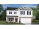 Charming two-story home featuring stone accents, attached two-car garage, and meticulously manicured landscaping at 196 Ethel Ln, Angier, NC 27501