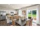 Bright open floorplan featuring a stylish kitchen with white cabinetry and an island with bar seating at 196 Ethel Ln, Angier, NC 27501