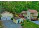 Aerial view of a house, detached garage, workshop, long driveway, and wooded grounds at 196 Tara Ln, Timberlake, NC 27583
