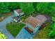 Aerial view showcasing the house, detached garage, workshop, and gravel driveway at 196 Tara Ln, Timberlake, NC 27583