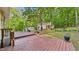 Expansive backyard deck overlooks lush greenery and additional storage buildings, offering privacy and outdoor living at 196 Tara Ln, Timberlake, NC 27583