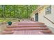 Multi-tiered backyard deck providing ample space for relaxation and entertainment, seamlessly blends with the natural surroundings at 196 Tara Ln, Timberlake, NC 27583