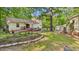 Well-manicured backyard with a deck, landscaping, and outbuildings perfect for outdoor enjoyment and relaxation at 196 Tara Ln, Timberlake, NC 27583