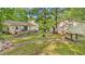 Large backyard featuring a deck, garden, and wooded backdrop perfect for outdoor living and entertaining at 196 Tara Ln, Timberlake, NC 27583