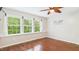 A bedroom featuring wood-look floors, and three windows at 196 Tara Ln, Timberlake, NC 27583