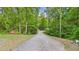 Entrance to a private drive surrounded by lush greenery and mature trees at 196 Tara Ln, Timberlake, NC 27583