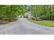 Charming two-story home featuring a long gravel driveway and mature trees at 196 Tara Ln, Timberlake, NC 27583