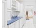Galley-style kitchen with white cabinets and contrasting blue countertops at 196 Tara Ln, Timberlake, NC 27583