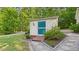 Charming shed with a custom door and stone pathway blends functionality with the beauty of nature at 196 Tara Ln, Timberlake, NC 27583