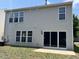 Back of home featuring multiple windows and a sliding glass door that opens to a small patio at 2018 Groundwater Pl, Raleigh, NC 27610