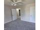 Neutral bedroom with plush carpet, ceiling fan, and access to an ensuite bathroom at 2018 Groundwater Pl, Raleigh, NC 27610