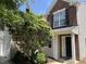 Charming brick-accented home with a black front door and lush greenery framing the entrance at 2018 Groundwater Pl, Raleigh, NC 27610
