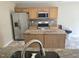 Well-lit kitchen featuring stainless steel appliances and a granite-topped island at 2018 Groundwater Pl, Raleigh, NC 27610