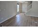 Inviting living room showcasing wood floors, a staircase, and natural light through a window at 2018 Groundwater Pl, Raleigh, NC 27610