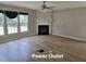 Open-concept living area featuring a fireplace, hardwood floors, and windows at 2018 Groundwater Pl, Raleigh, NC 27610