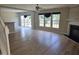 Cozy living room with hardwood floors, fireplace and three windows for natural light at 2018 Groundwater Pl, Raleigh, NC 27610
