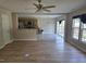 Bright and open living space featuring hardwood floors, access to kitchen, dining area, and sliding glass door at 2018 Groundwater Pl, Raleigh, NC 27610