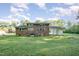 Brick home featuring a spacious backyard, ideal for outdoor activities at 2027 Jefferson Dr, Hillsborough, NC 27278