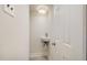 Cozy powder room with wall mounted sink and light wood look flooring at 2027 Jefferson Dr, Hillsborough, NC 27278