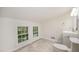 Cozy bathroom with tile flooring, a new toilet, and double windows at 2027 Jefferson Dr, Hillsborough, NC 27278