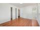 Bright bedroom featuring hardwood floors, a closet with louvered doors, and neutral walls at 2027 Jefferson Dr, Hillsborough, NC 27278
