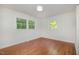 Bedroom with hardwood floors and dual windows providing ample natural light at 2027 Jefferson Dr, Hillsborough, NC 27278
