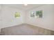 Carpeted bedroom featuring natural light from the windows with outdoor views at 2027 Jefferson Dr, Hillsborough, NC 27278