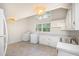 Spacious kitchen with white cabinets, countertops, matching appliances and plenty of natural light at 2027 Jefferson Dr, Hillsborough, NC 27278